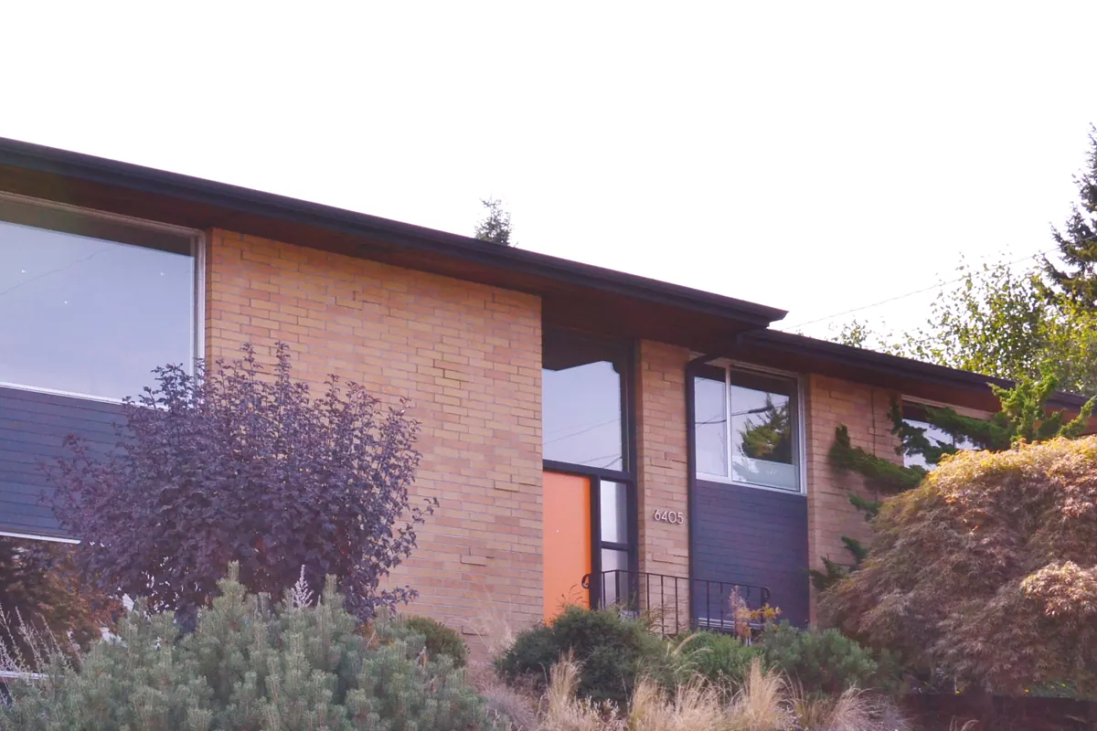 Illustrative photo, not this property: a mid-century modern house with large corner windows