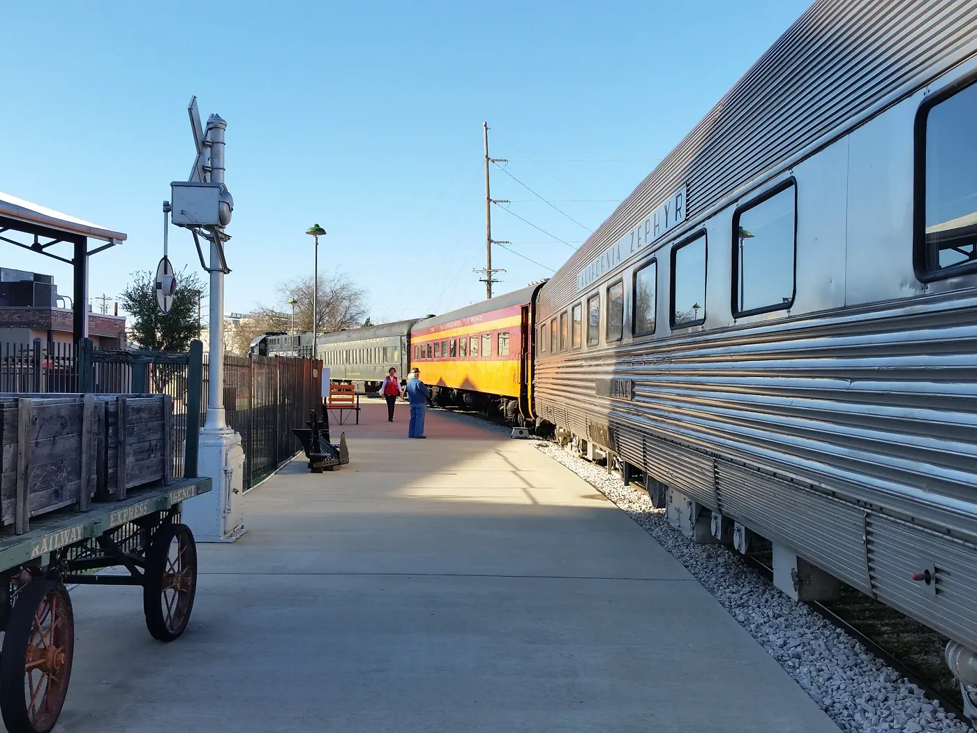 A vintage passenger train beside the platform at the Cedar Park Depot